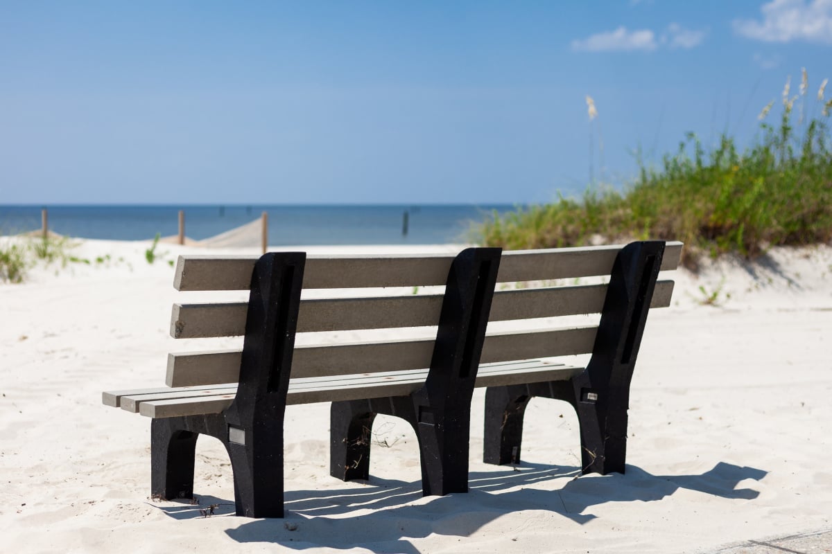 Bench on white sand in Bay St. Louis, Mississippi