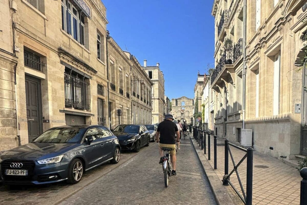 Original Photo Of Tyler Fox Editor In Chief Travel Off Path Riding bike through streets of Bordeaux France